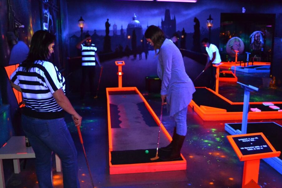 Prague: Glow Golf Mini Golf Game by UV Light - The Prague murals add more than decoration