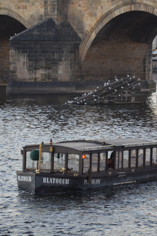 Prague: Old Town Guided Walking Tour and City Boat Ride - Cruising beneath Charles Bridge toward Prague Castle