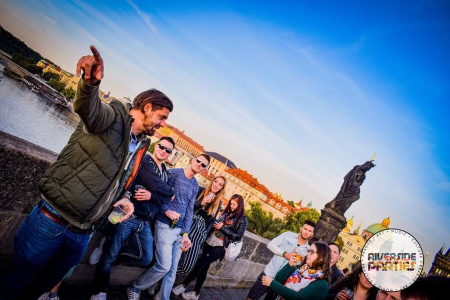 Prague Riverside Parties Tour - Crossing Charles Bridge with the group