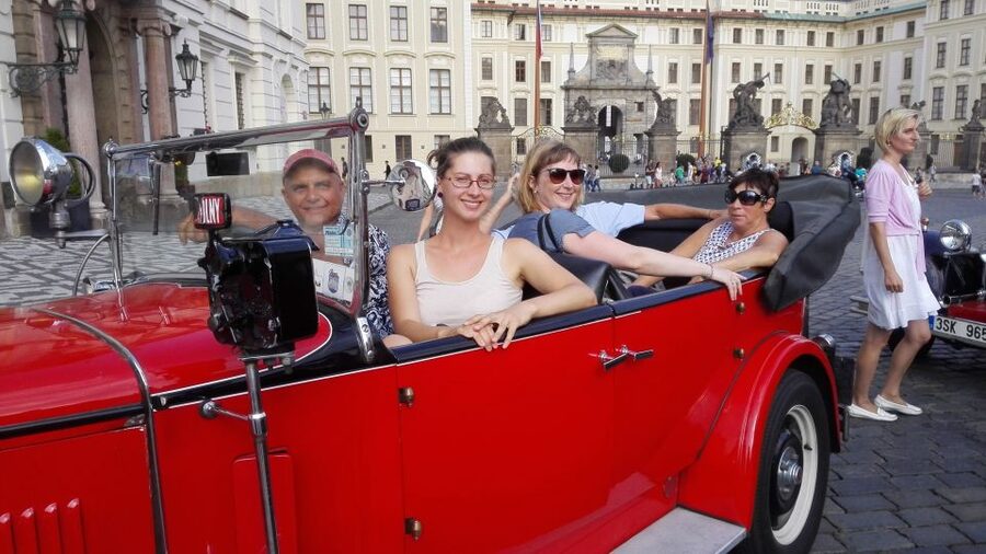 Prague: Vintage Car Ride and Walking Tour - Walking from the castle toward Charles Bridge